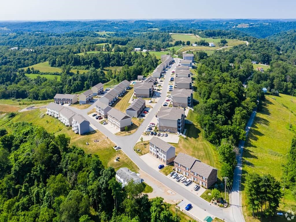 an aerial view of a village with buildings and a highway
