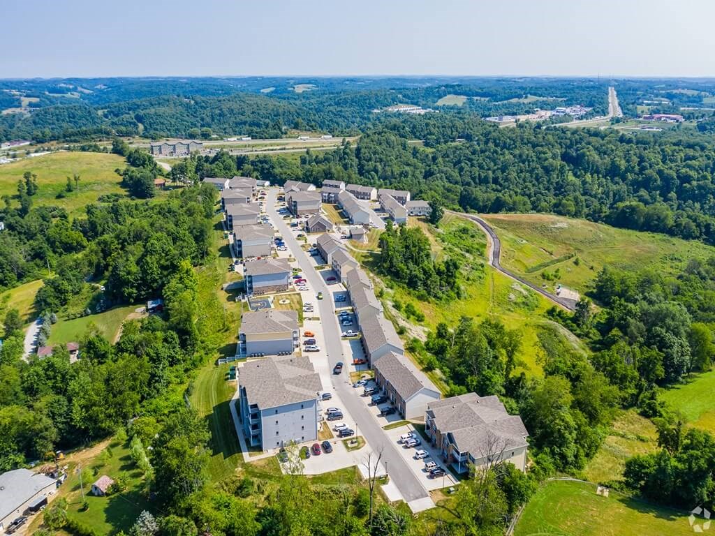 an aerial view of a city street with buildings and trees