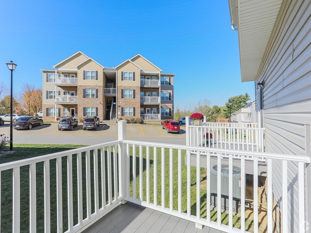 the view from the balcony of an apartment building with a white railing
