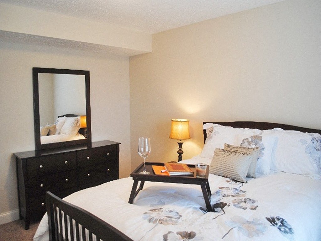 a bedroom with a bed and a mirror