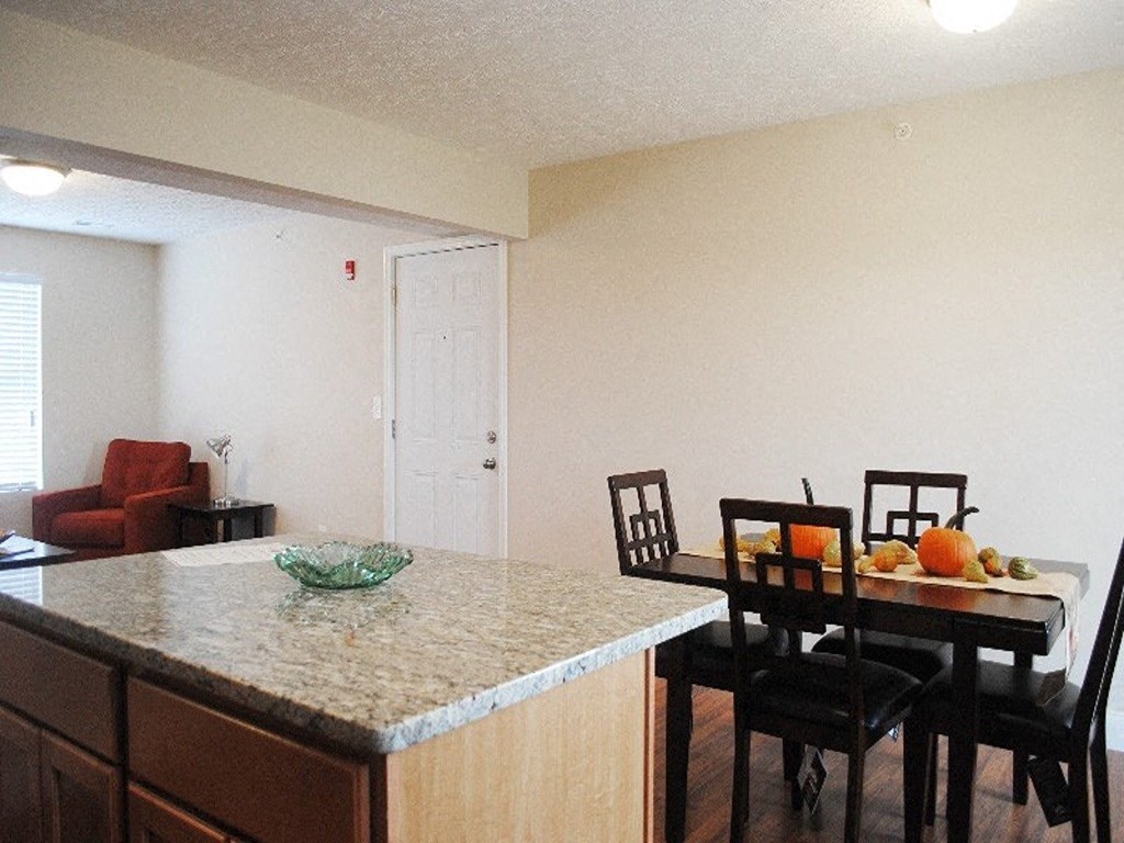 a kitchen and dining room with a table and chairs