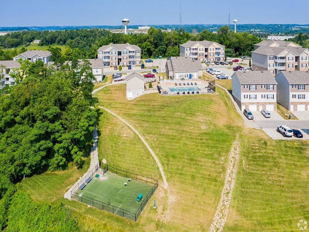 a city with a tennis court in front of houses