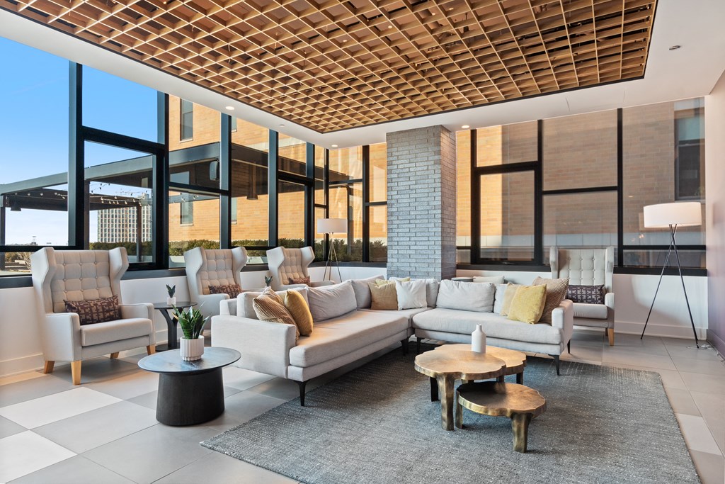 a living room with couches and chairs in front of a window