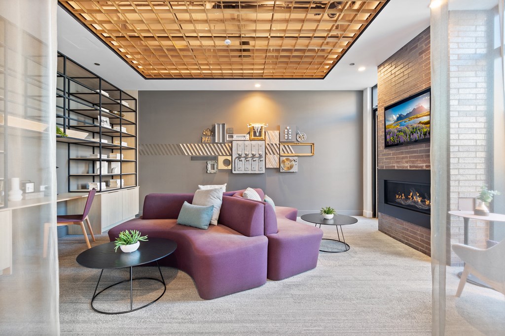 a living room with a purple couch and a fireplace
