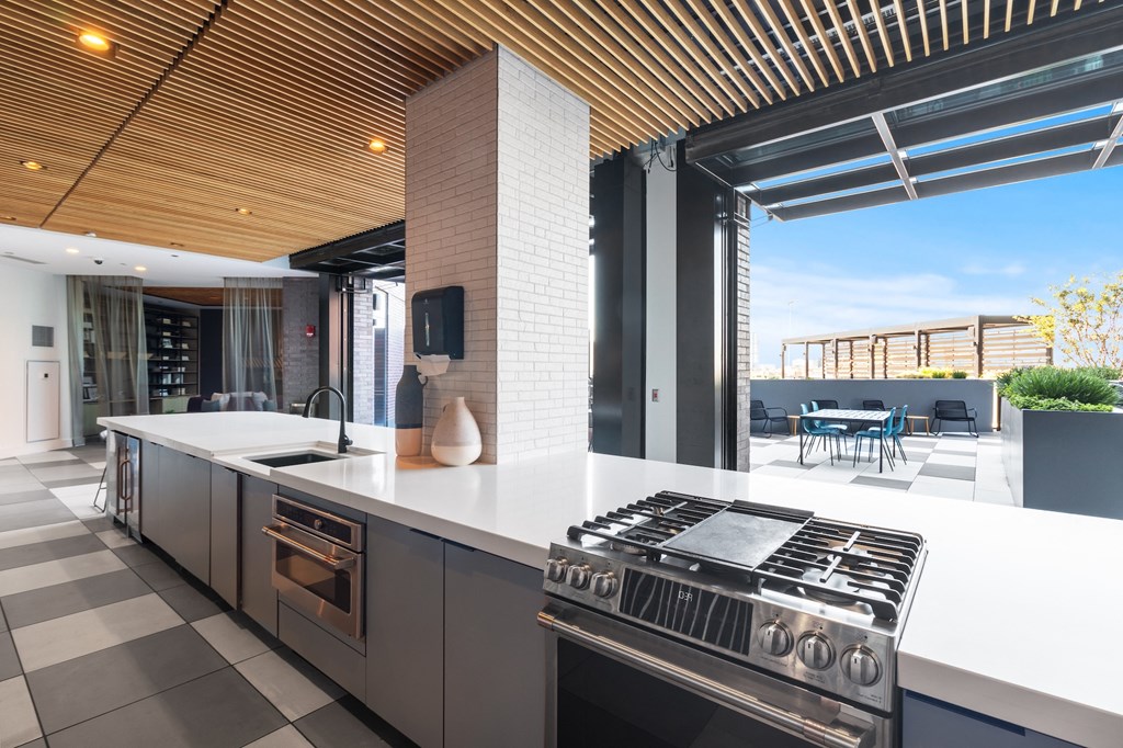 a kitchen with an island and a stove and a patio