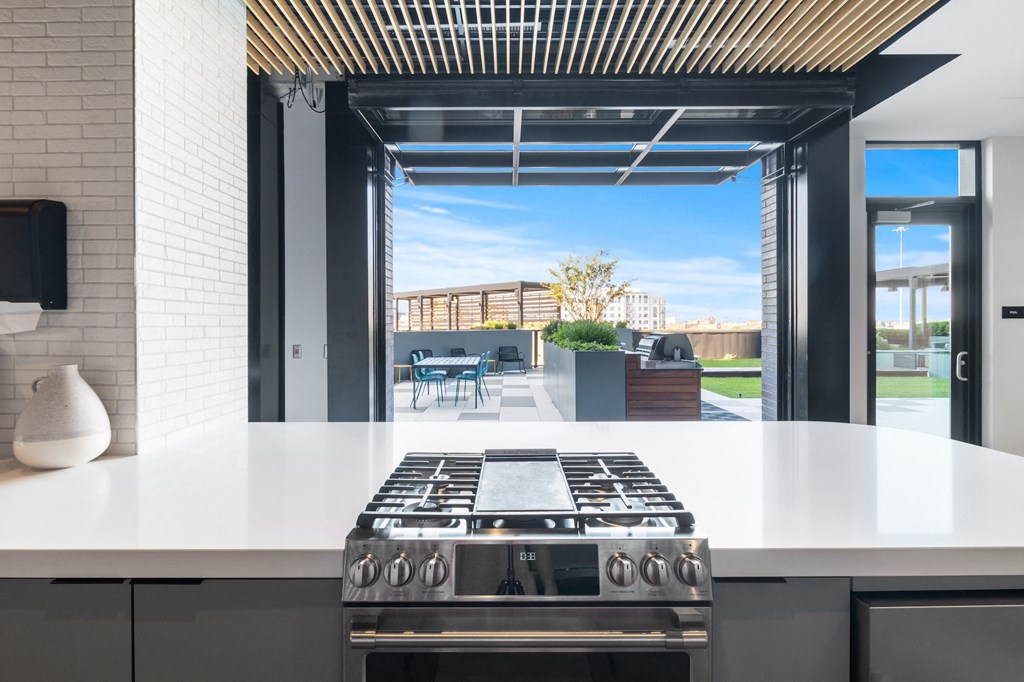 a kitchen with a stove and a view of a patio