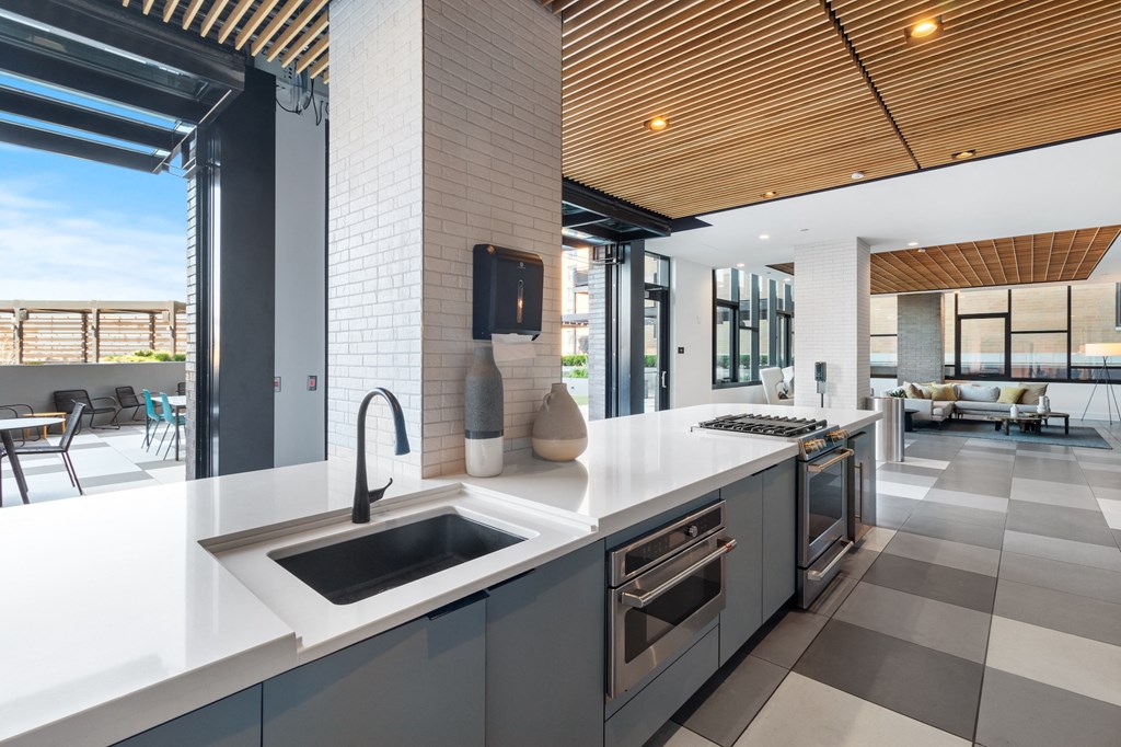 a kitchen with white countertops and a sink in a house