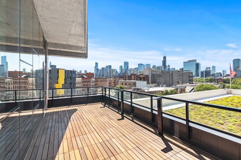 the view of the skyline from the rooftop deck of a building with wood