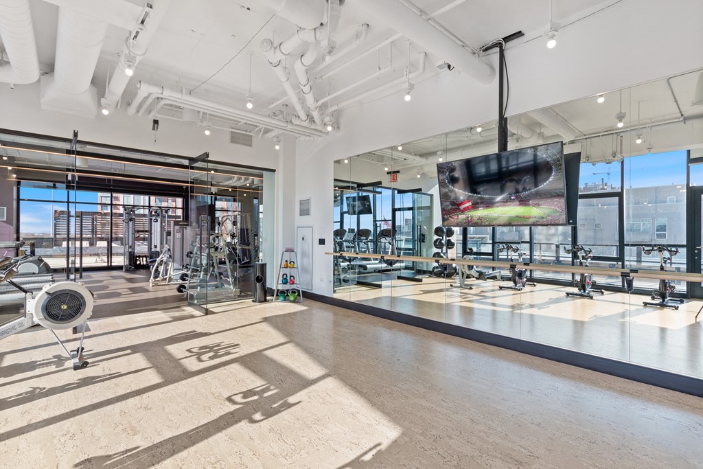 a view of the floor of a brewery with beer machines and a large window