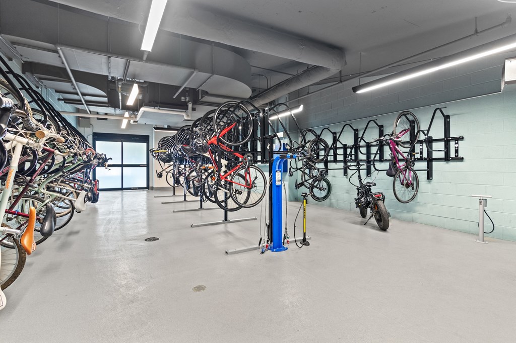 a large room filled with bikes and bikes hanging on a wall