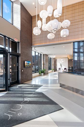 the lobby of a building with glass doors and a reception desk