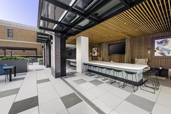 a rendering of the lobby of a restaurant with a bar and tables