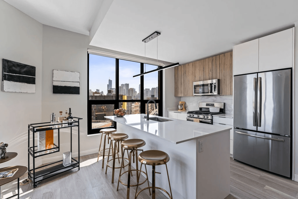 a kitchen with a large center island with a breakfast bar and stools