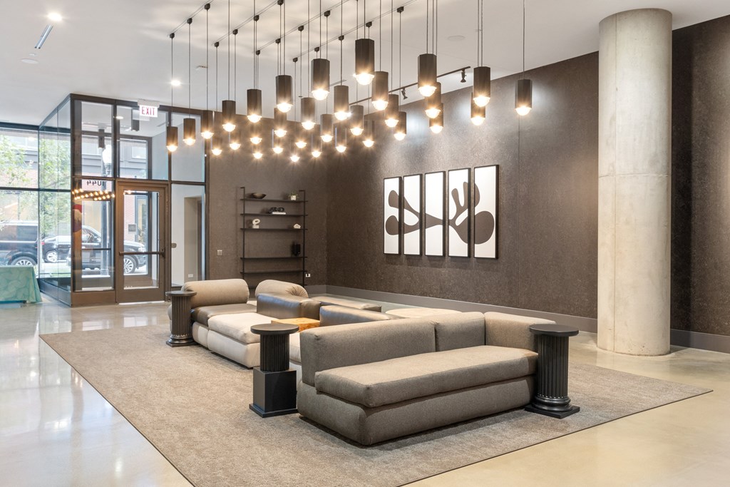 a rendering of a lobby with couches and tables