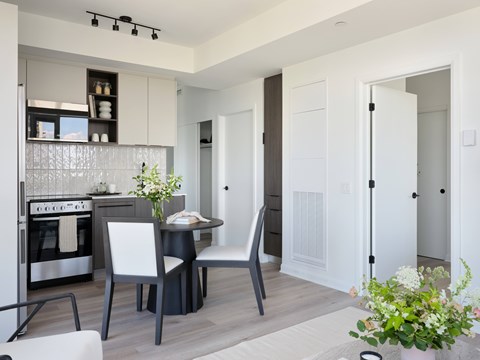 A modern kitchen with a dining table and chairs.