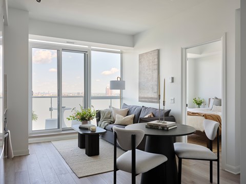 A black and white living room with a view of the city.