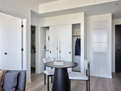 A modern dining room with a round table and chairs.