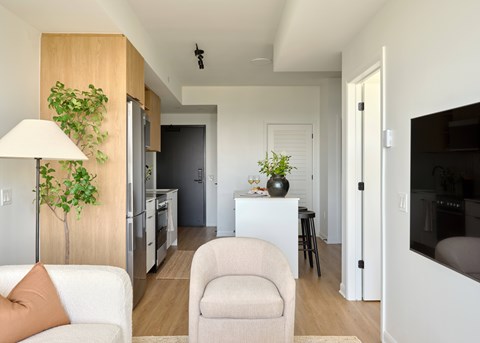 A living room with a white couch and a lamp.