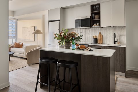 A kitchen with a white counter top and a white fridge.