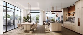 A modern kitchen with a dining table and chairs.