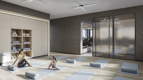 a woman sitting on the floor in a yoga room