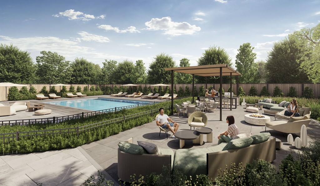 A poolside area with people sitting and enjoying the sun.