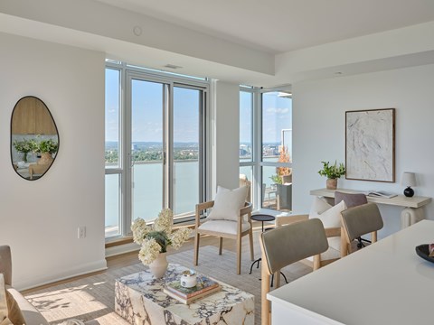 A living room with a view of the city through the windows.