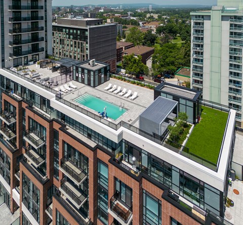 an aerial view of a building with a pool on top of it