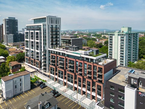 an aerial view of a large brick building with a green roof on top of it
