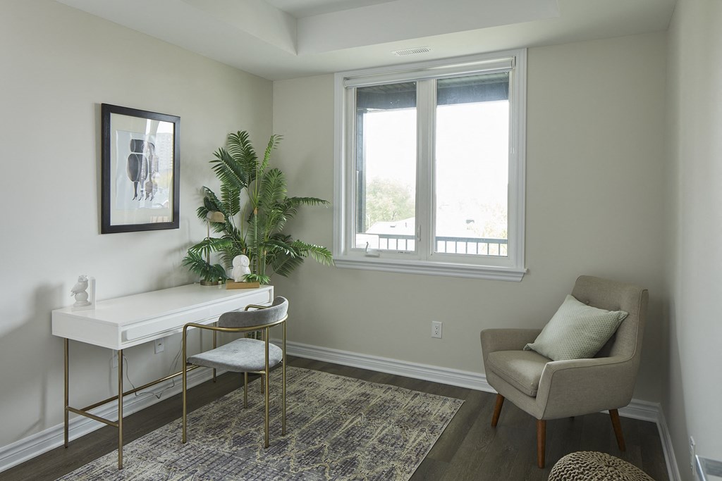 a home office with a desk and chair and a window