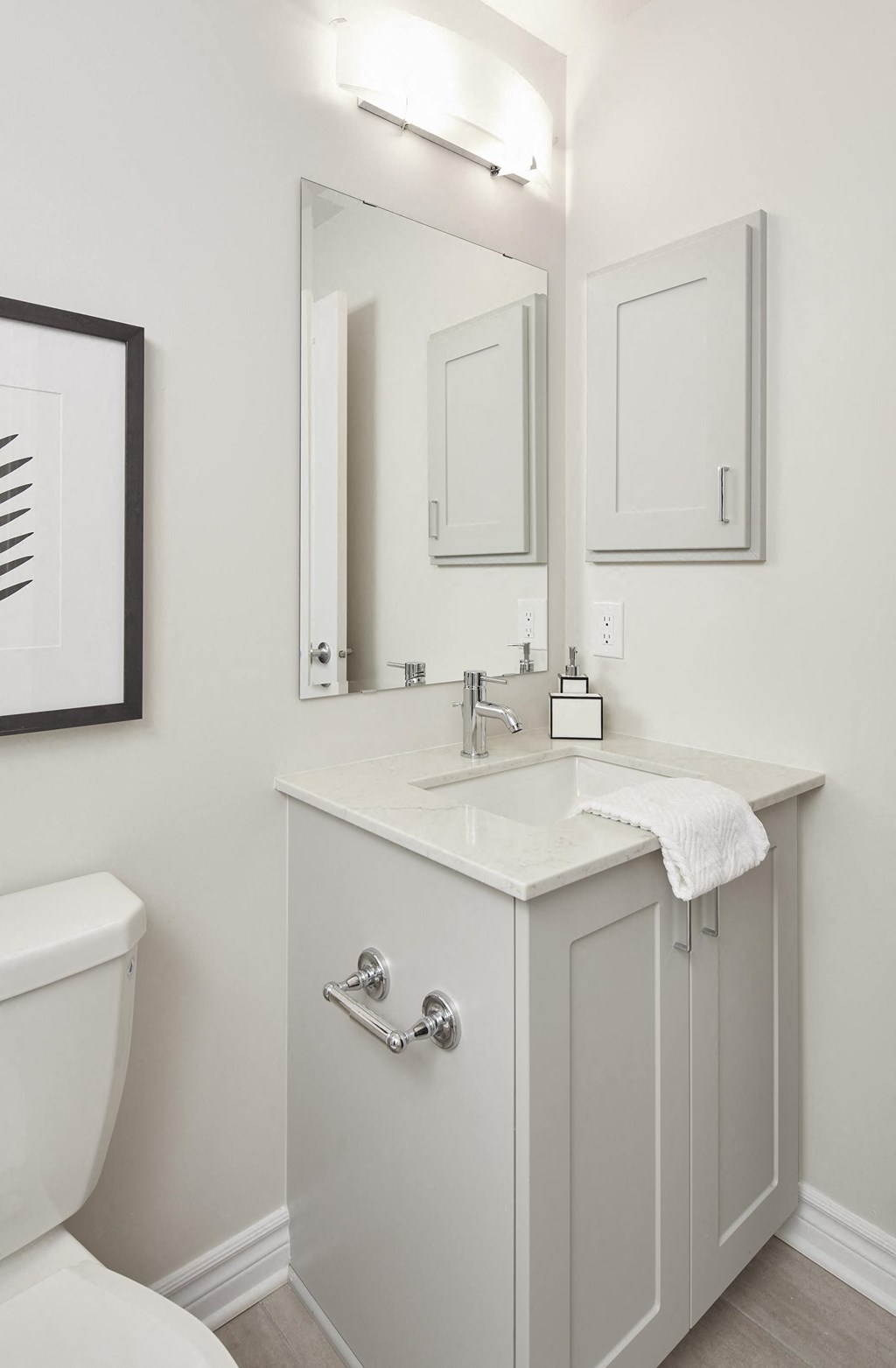 a white bathroom with a sink and a toilet