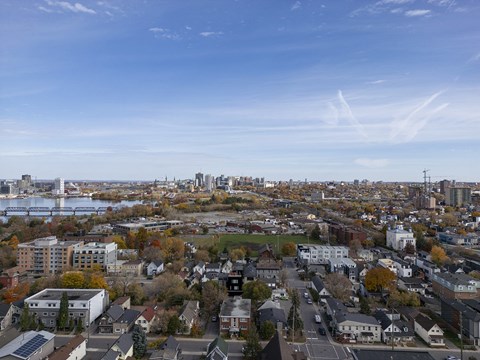 an aerial view of a city with a river and a city skyline