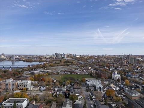 an aerial view of the city with a river and a city skyline