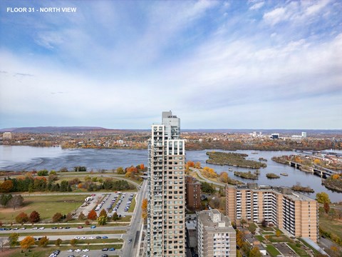 an aerial view of a city with tall buildings and a river