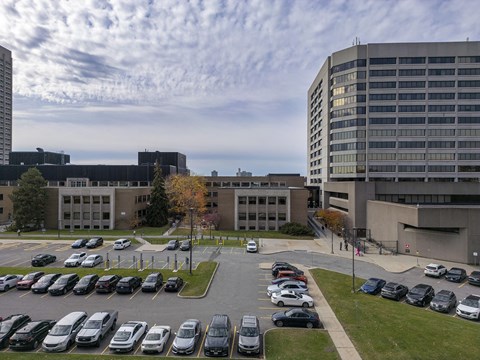 a parking lot in front of a building with cars parked