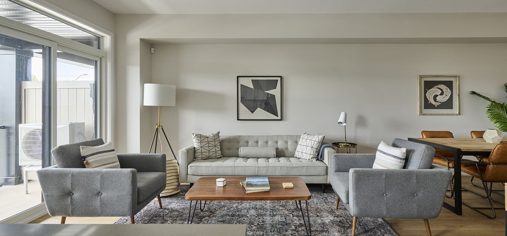 a living room with couches and chairs and a table