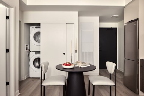 A modern kitchen with a table set for two.