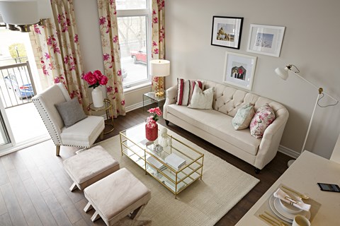 a living room with a white couch and two chairs and a coffee table