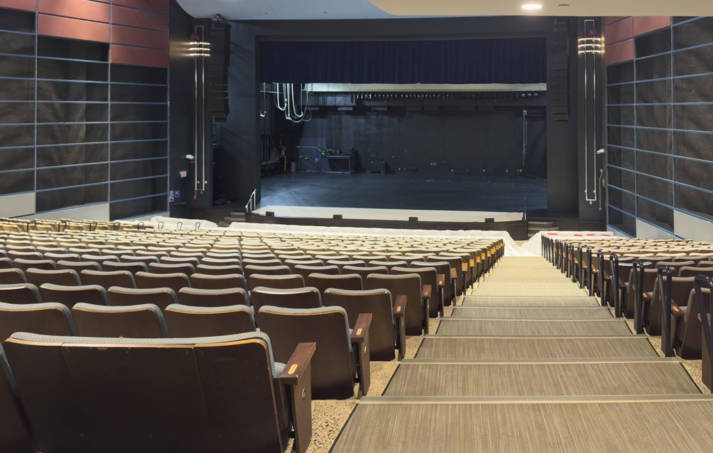 A large auditorium with rows of seats facing a stage.