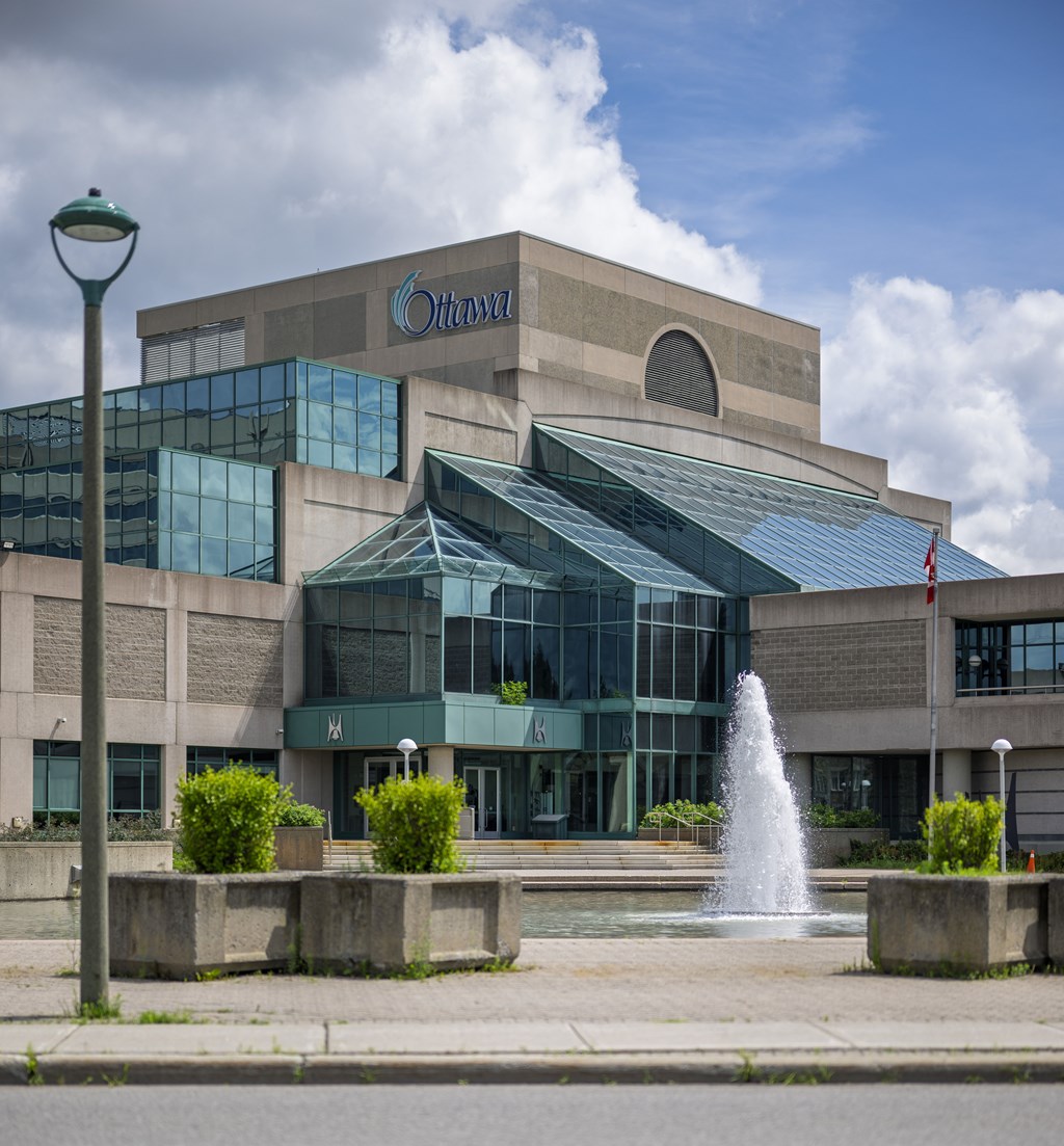 A modern building with a fountain in front.