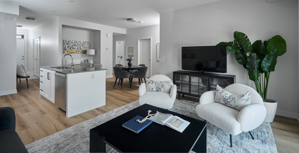 a living room with white furniture and a black coffee table