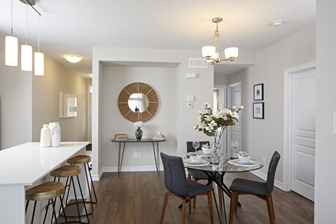 a living room and dining room with a table and chairs