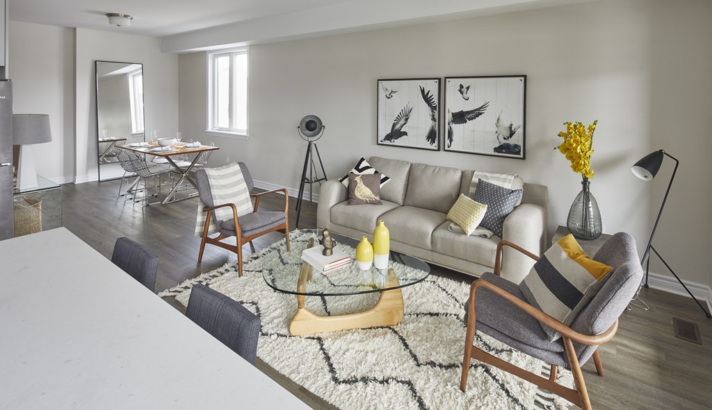 a living room with a couch and chairs and a table