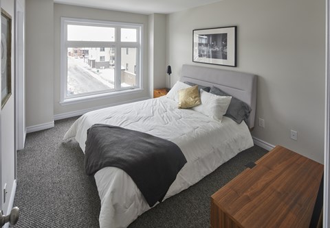 a bedroom with a large bed and a window