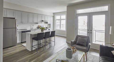 a kitchen and living room with an island and a refrigerator