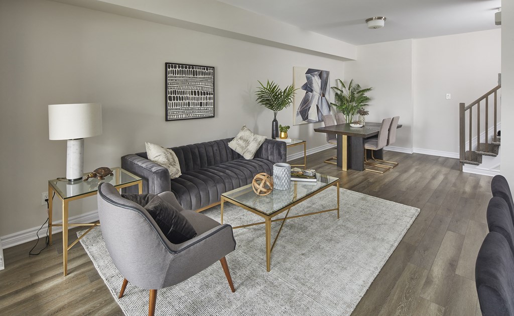 an open living room and dining room with a couch and chairs