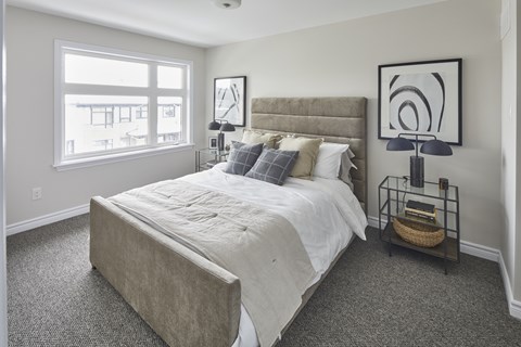 a bedroom with a large bed and a window