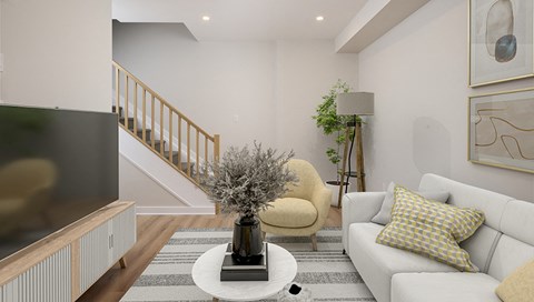 a living room with a couch and a coffee table and a staircase