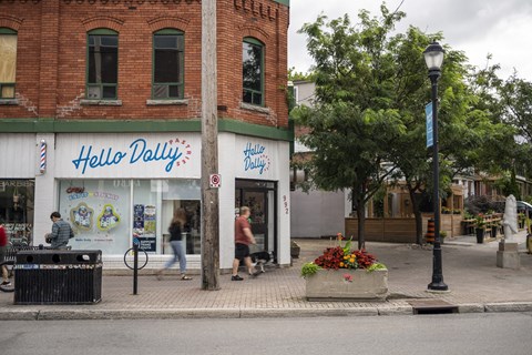 people walking down a street in front of a store
