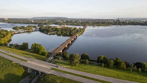 an aerial view of a bridge over a body of water and a highway